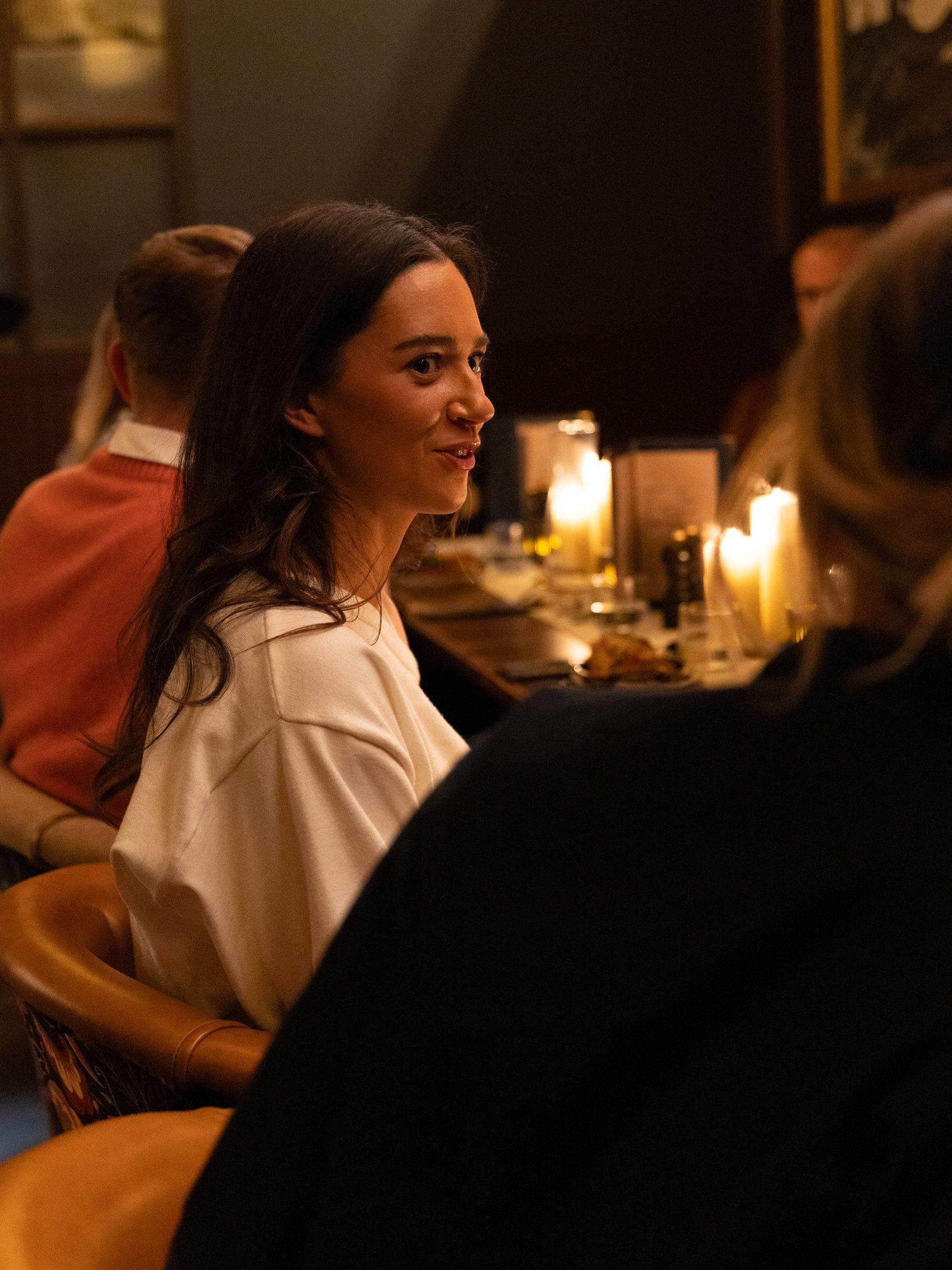 A founder in conversation at a candlelit Focus on Founders roundtable dinner